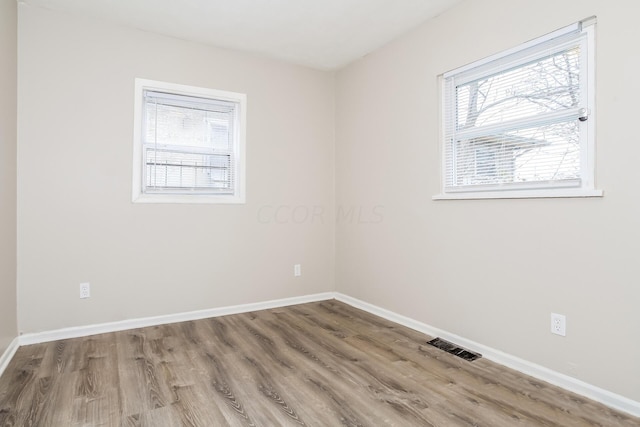 empty room with hardwood / wood-style flooring