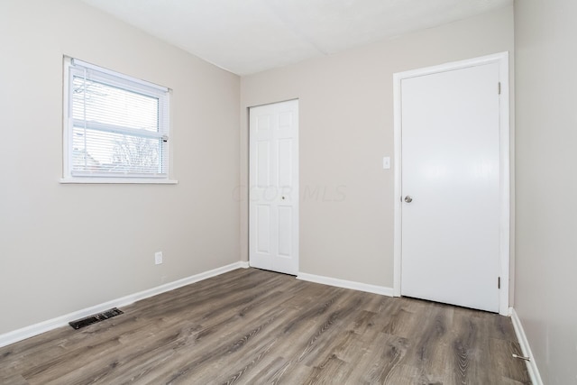 1328 Kent St, Columbus, OH 43205 - unfurnished bedroom with wood finished floors and a closet