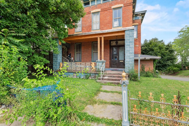 view of front of property with a porch and a front yard