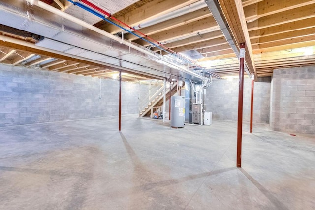 unfinished basement with electric water heater and heating unit