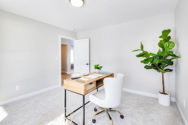 home office featuring carpet and baseboards