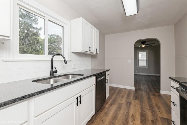 kitchen featuring dark wood-type flooring, dark stone counters, sink, ceiling fan, and white cabinetry