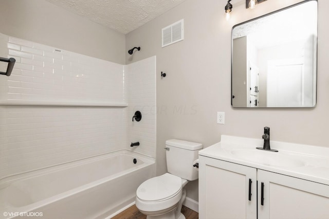 full bathroom with vanity, a textured ceiling, wood-type flooring, shower / tub combination, and toilet