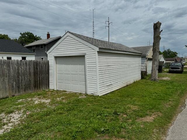 garage featuring a lawn