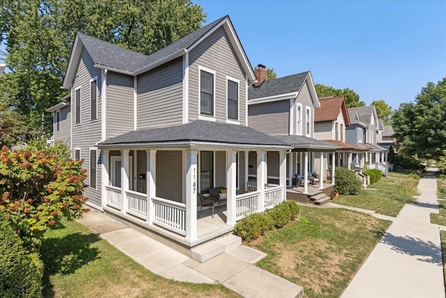 view of home's exterior featuring a lawn and covered porch