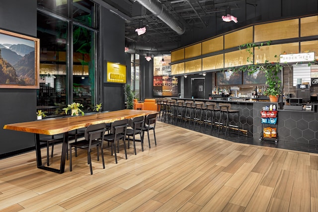 bar featuring light wood-type flooring