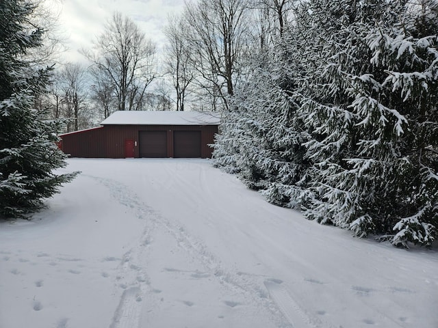 exterior space featuring a garage and an outbuilding