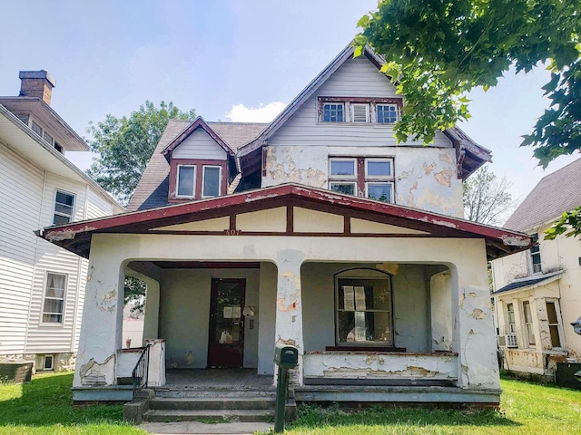 view of front of property featuring cooling unit and covered porch