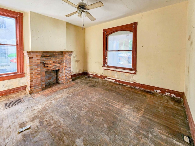 unfurnished living room featuring a fireplace and ceiling fan