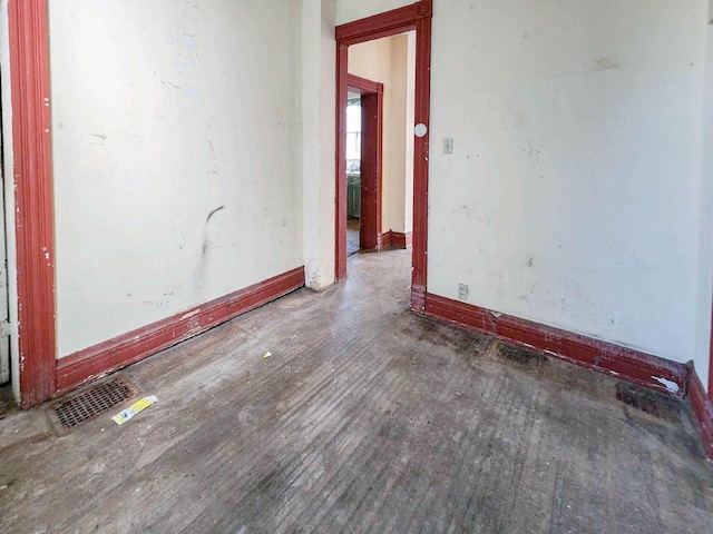 empty room with dark wood-type flooring