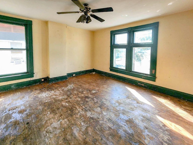 unfurnished room featuring plenty of natural light and ceiling fan