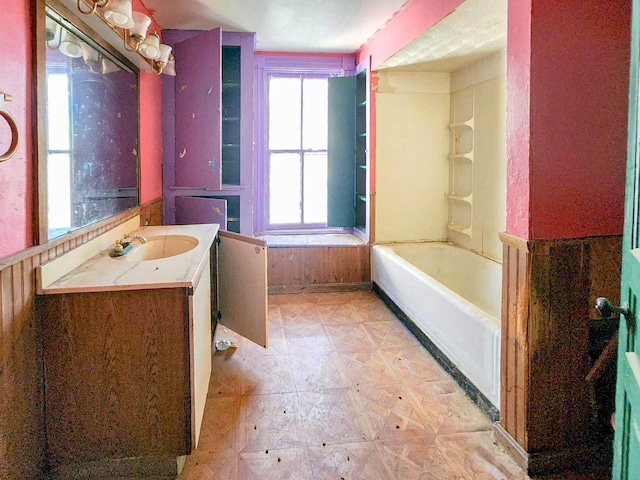 bathroom with vanity and a tub to relax in