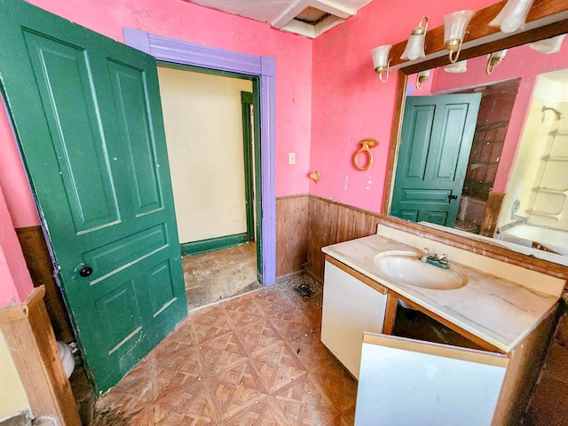 bathroom featuring parquet flooring, vanity, shower / washtub combination, and wood walls