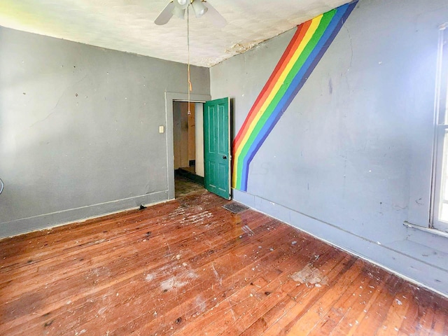 spare room with ceiling fan and hardwood / wood-style flooring