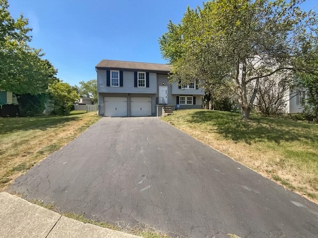 bi-level home featuring a front yard and a garage