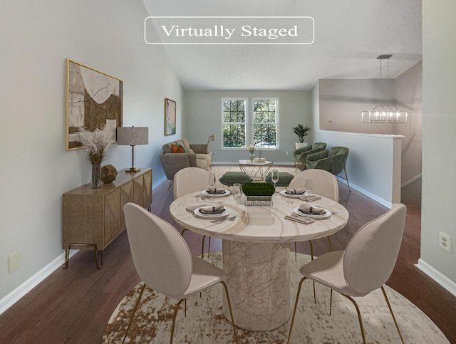 dining space featuring vaulted ceiling, dark wood-type flooring, and a notable chandelier