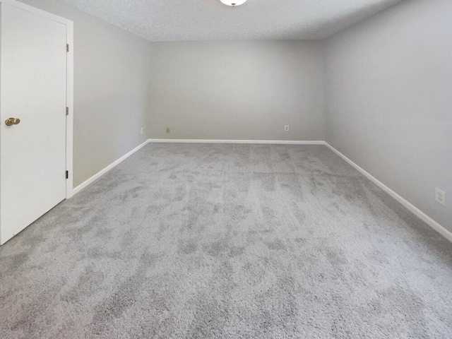 unfurnished room featuring carpet floors and a textured ceiling