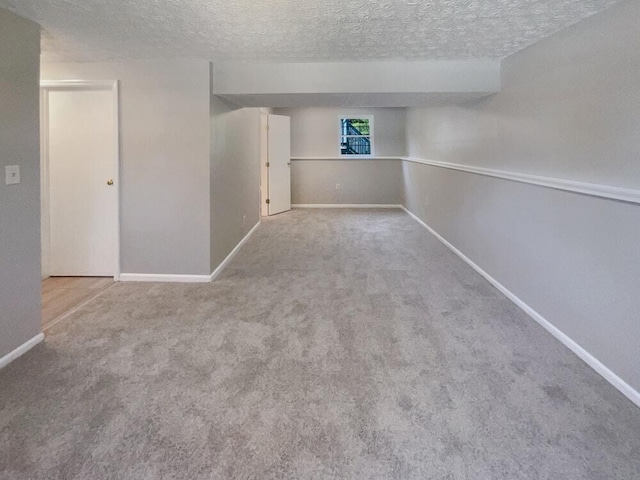 empty room with carpet and a textured ceiling