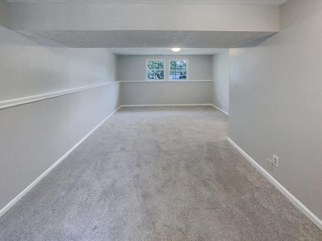 basement with carpet and a textured ceiling