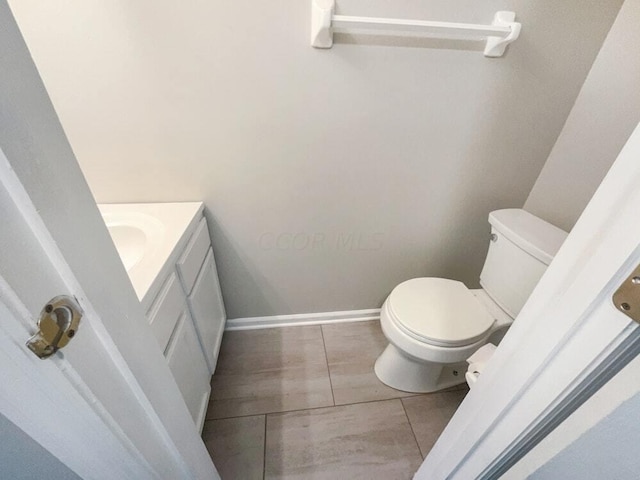 bathroom with tile patterned floors, vanity, and toilet