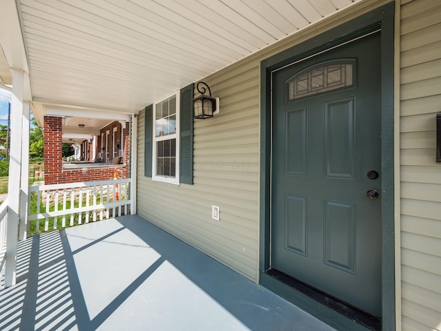 view of exterior entry with a porch