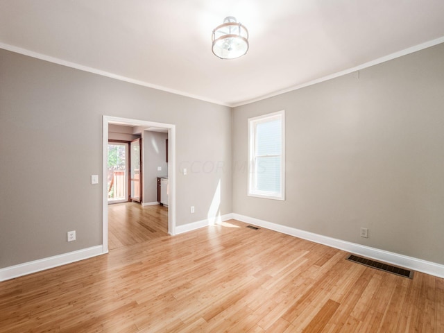 spare room with light hardwood / wood-style flooring and ornamental molding