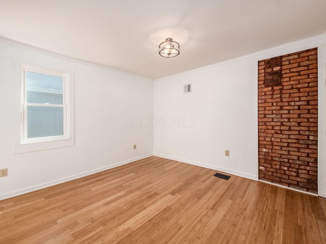 unfurnished room featuring crown molding and wood-type flooring