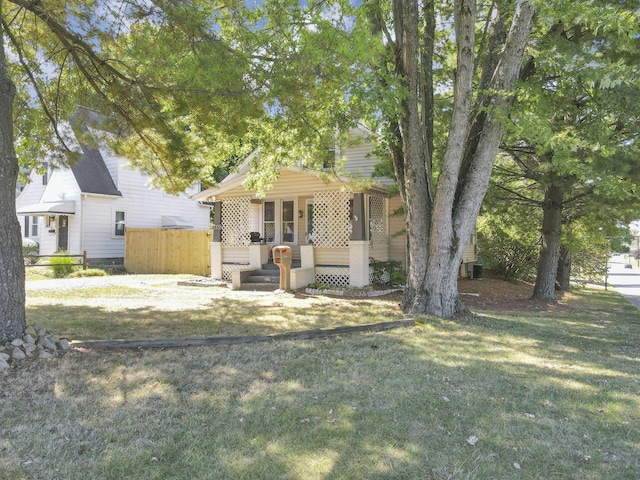 view of front of property with covered porch and a front lawn