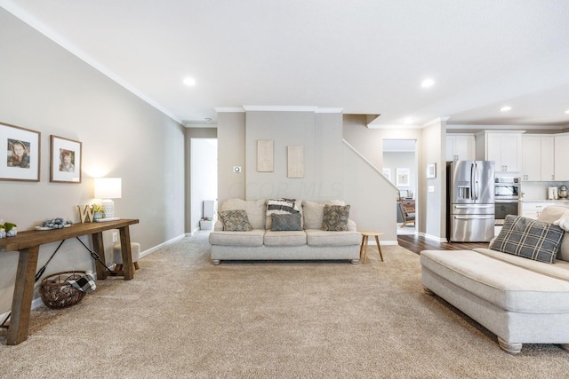 carpeted living room featuring crown molding