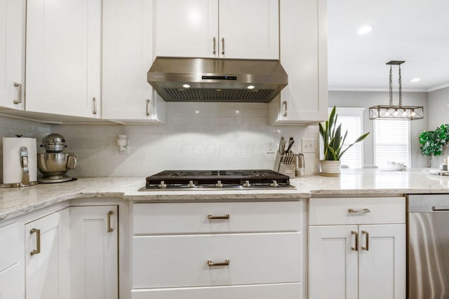 kitchen with appliances with stainless steel finishes, decorative light fixtures, light stone counters, white cabinetry, and extractor fan