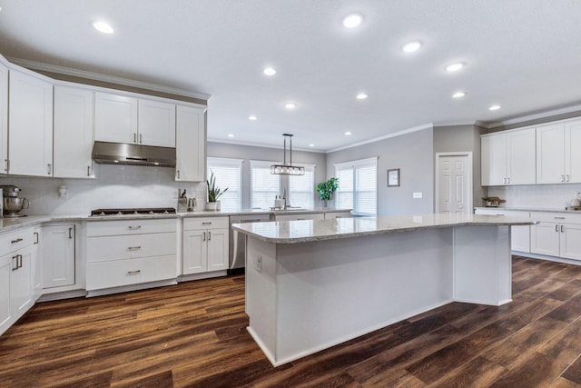 kitchen featuring a center island, dark wood-type flooring, and appliances with stainless steel finishes