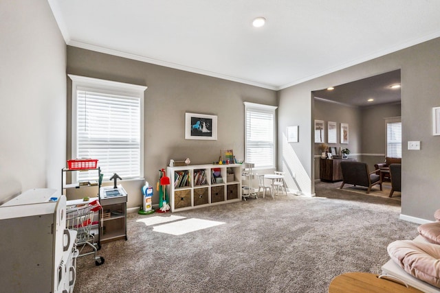 playroom with plenty of natural light, carpet, and ornamental molding