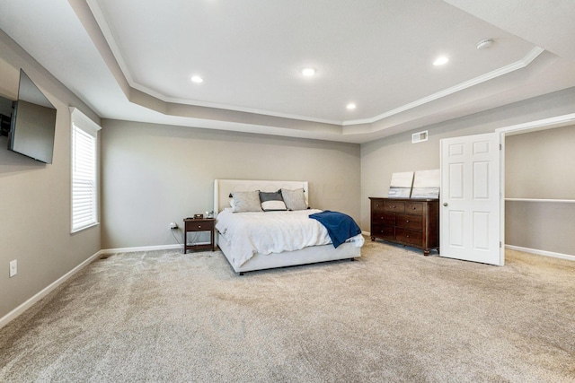 bedroom featuring light carpet, a raised ceiling, and ornamental molding