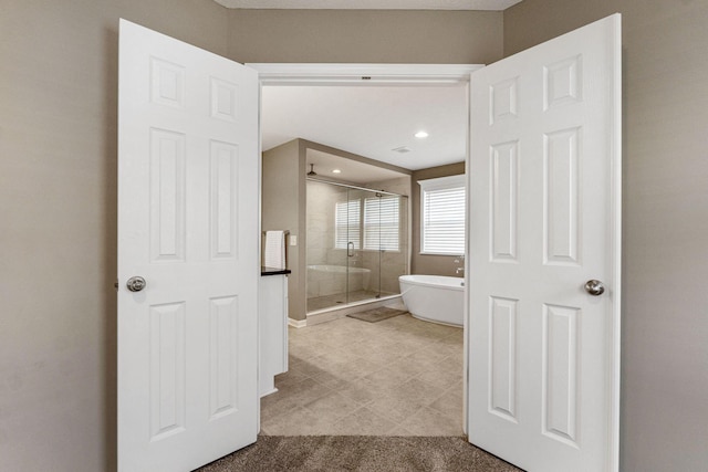 bathroom featuring shower with separate bathtub