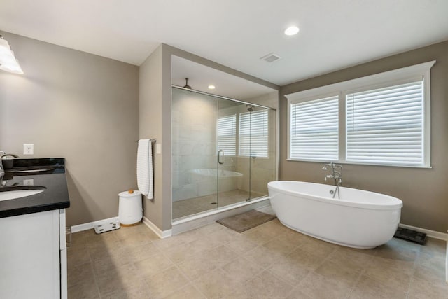 bathroom with tile patterned flooring, vanity, and independent shower and bath