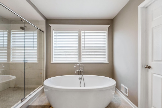 bathroom with tile patterned flooring and plus walk in shower