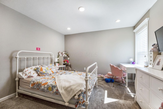 bedroom with dark colored carpet