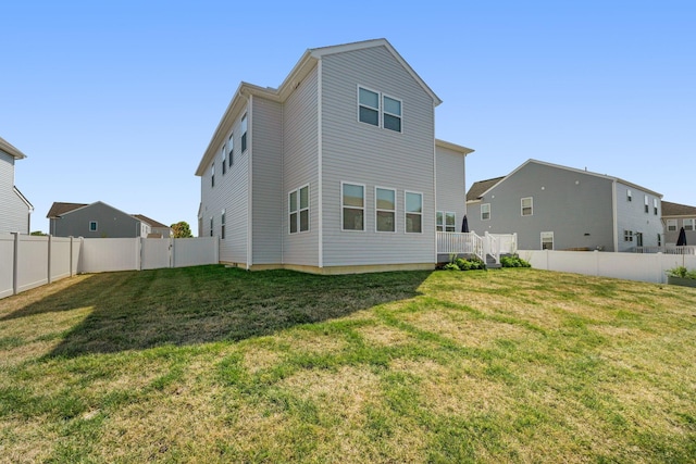 rear view of house featuring a yard and a wooden deck