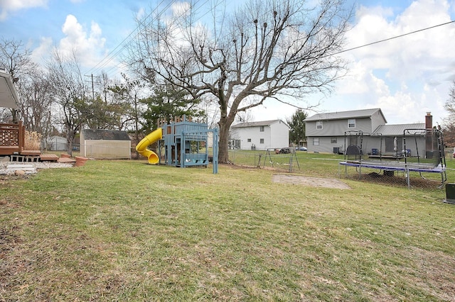 view of yard with a playground and a trampoline