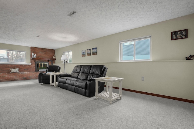 carpeted living room featuring a textured ceiling