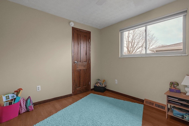 interior space with hardwood / wood-style floors and a textured ceiling