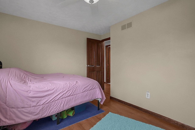 bedroom with wood-type flooring