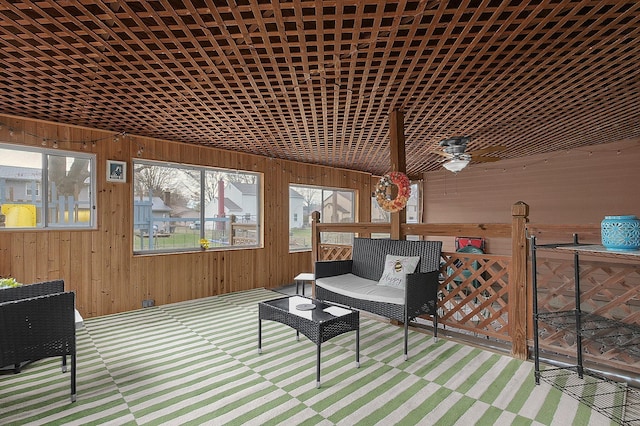 sunroom / solarium featuring ceiling fan