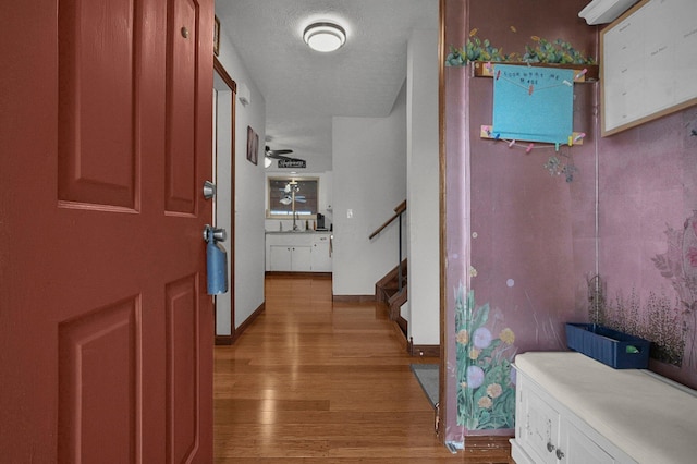 entryway featuring a textured ceiling and light wood-type flooring