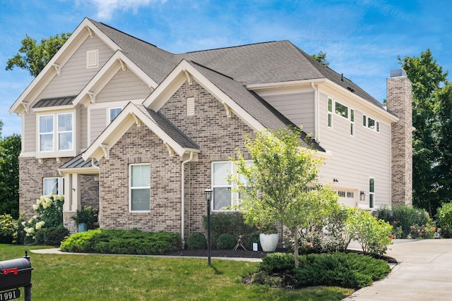 view of front of house featuring a front yard and a garage