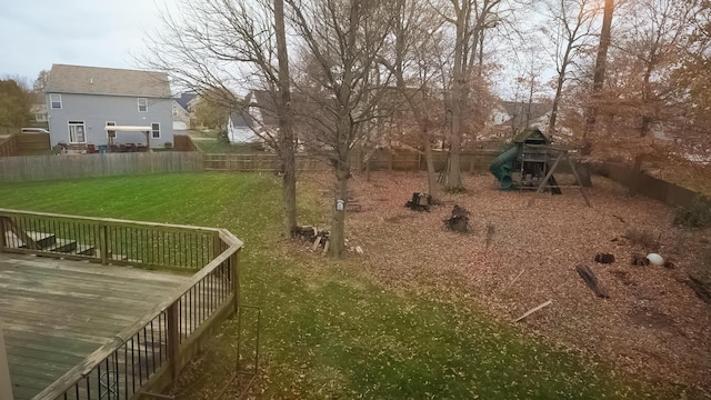 view of yard featuring a deck and a playground