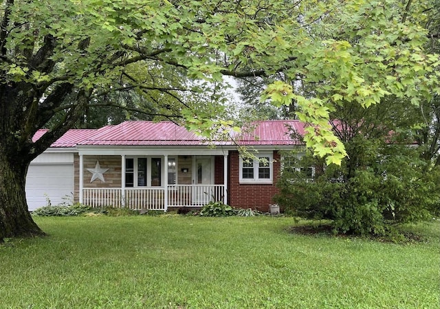 ranch-style house featuring covered porch, a garage, and a front lawn