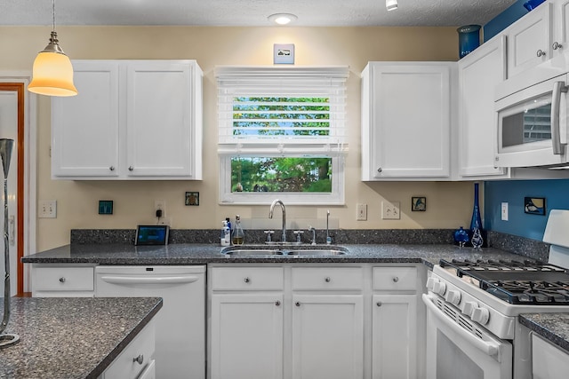 kitchen featuring a textured ceiling, white appliances, sink, white cabinetry, and hanging light fixtures