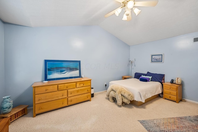 carpeted bedroom featuring ceiling fan and vaulted ceiling