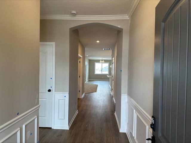 hall featuring crown molding and dark hardwood / wood-style flooring